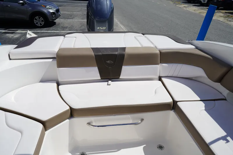 Slide: The Image of 2020 Chaparral 23 SSi OB boat interior with cushioned seating and outboard motor. - 9