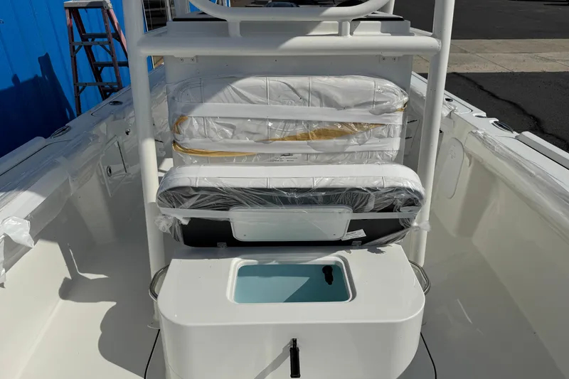 Slide: The Image of 2025 Parker 230 Coastal Elite boat interior with seating and storage features. - 12