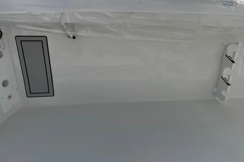 Slide: The Image of Interior view of 2025 Parker 230 Coastal Elite boat, featuring sleek white design elements. - 15