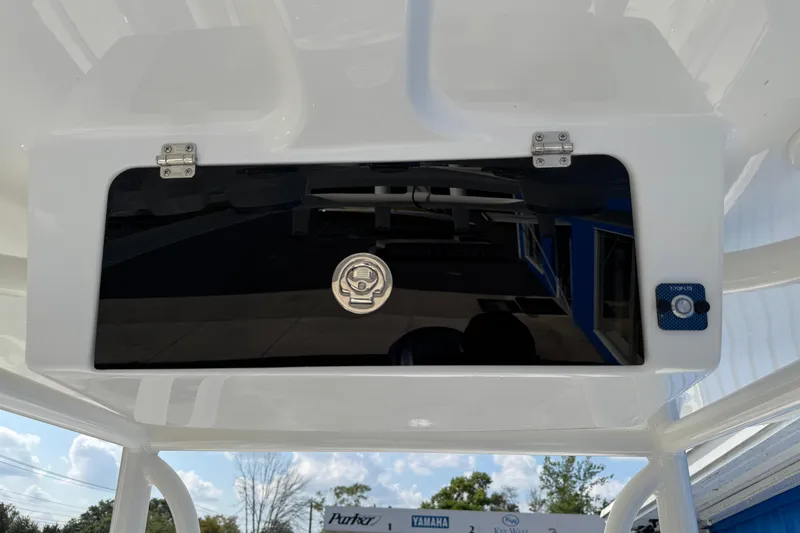 Slide: The Image of 2025 Parker 230 Coastal Elite boat console with storage compartment and latch. - 19