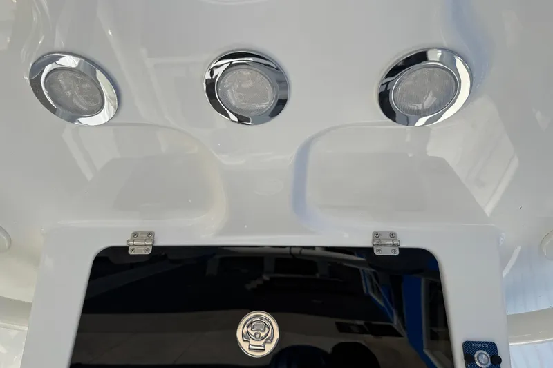 Slide: The Image of 2025 Parker 230 Coastal Elite boat with chrome fixtures and sleek design. - 20