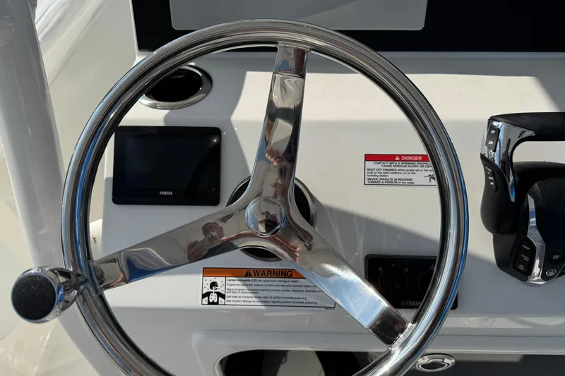 Slide: The Image of Steering wheel and controls of 2025 Parker 230 Coastal Elite boat. - 22