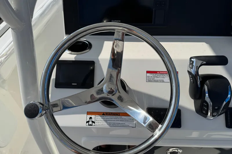 Slide: The Image of Steering wheel and controls of 2025 Parker 230 Coastal Elite boat. - 23