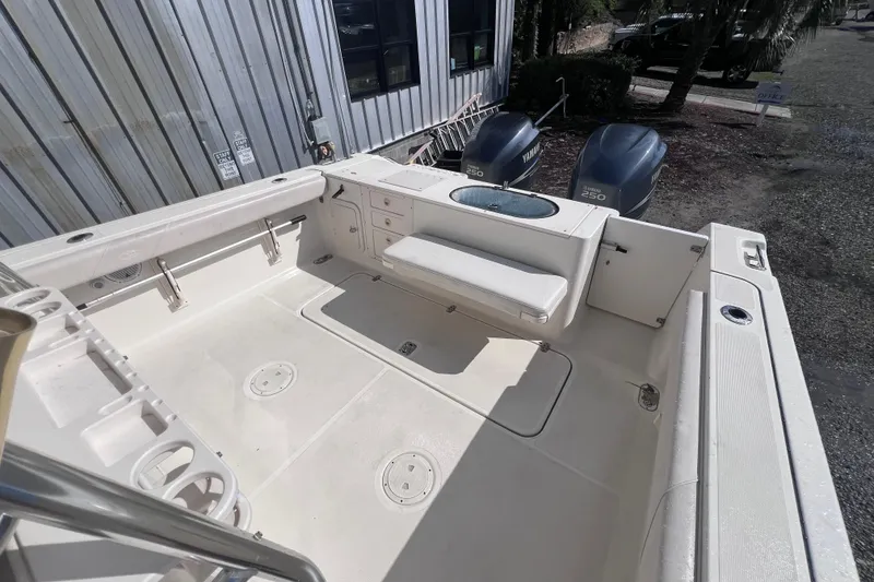 Slide: The Image of 2007 Pursuit C 300 Center Console boat on calm water, featuring dual Yamaha engines. - 10