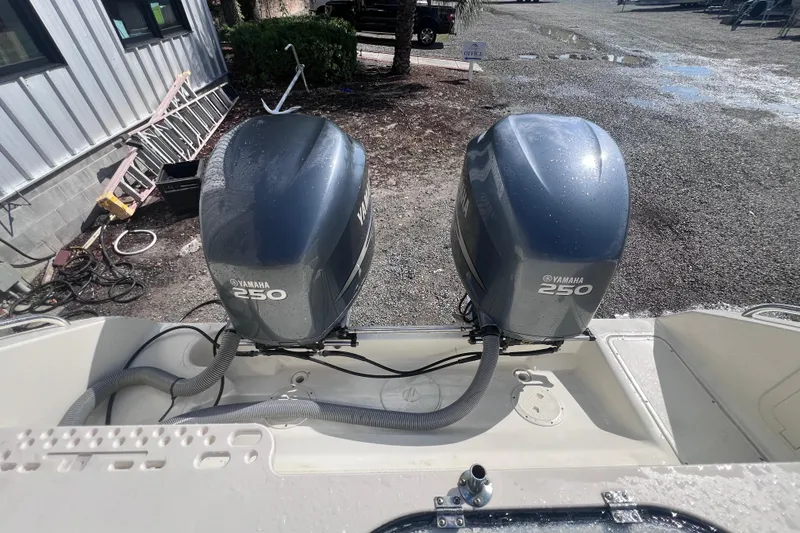 Slide: The Image of 2007 Pursuit C 300 Center Console boat on calm river with city skyline. - 11