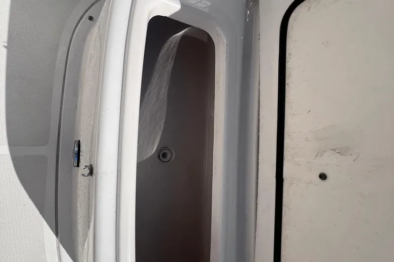 Slide: The Image of 2007 Pursuit C 300 Center Console boat interior with white paneling and speaker. - 14