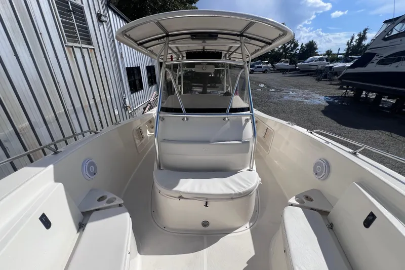 Slide: The Image of 2007 Pursuit C 300 Center Console boat on calm water under clear blue sky. - 16