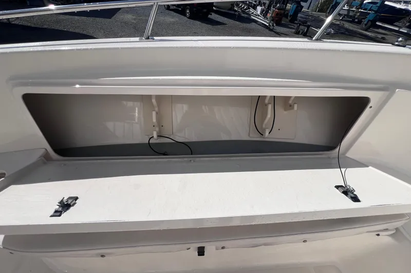 Slide: The Image of 2007 Pursuit C 300 Center Console boat on calm water, featuring a sleek helm design. - 18
