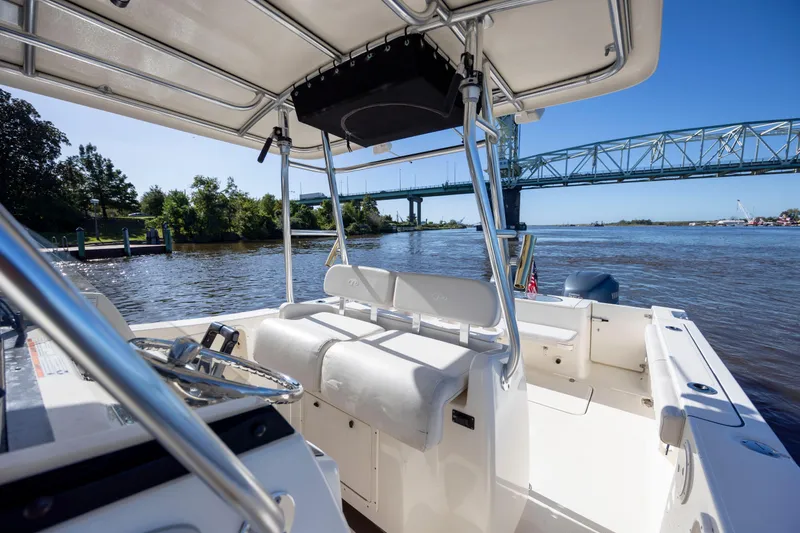 Slide: The Image of 2007 Pursuit C 300 Center Console boat on river near bridge, sunny day. - 20