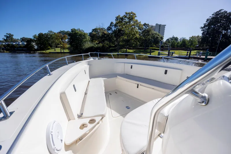 Slide: The Image of 2007 Pursuit C 300 Center Console boat interior with seating, on a sunny day by the water. - 21