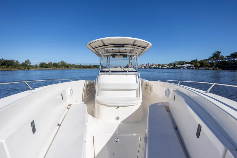 Slide: The Image of 2007 Pursuit C 300 Center Console boat on calm water, clear blue sky. - 23