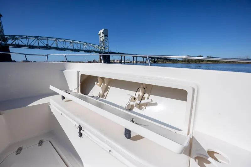 Slide: The Image of 2007 Pursuit C 300 Center Console boat with open storage, bridge in background. - 25