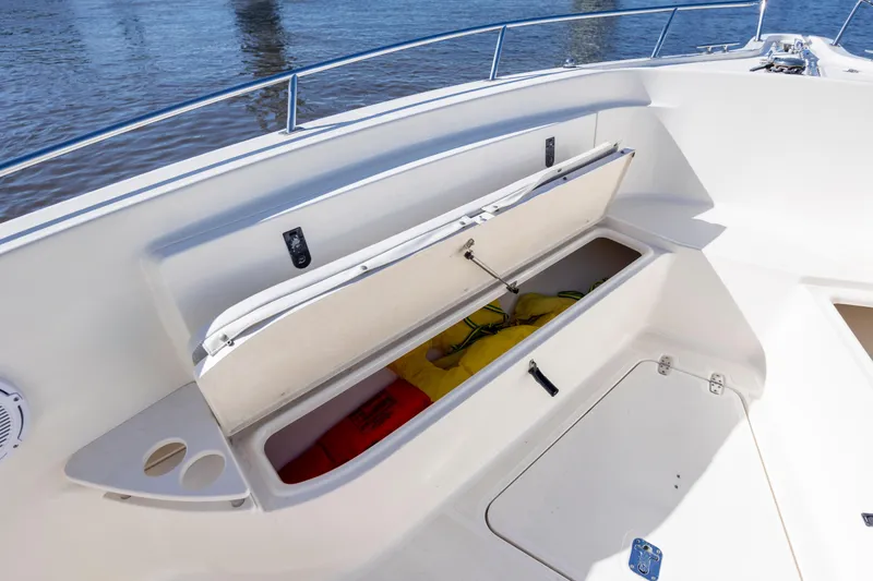 Slide: The Image of 2007 Pursuit C 300 Center Console boat with open storage compartment and life jackets. - 26