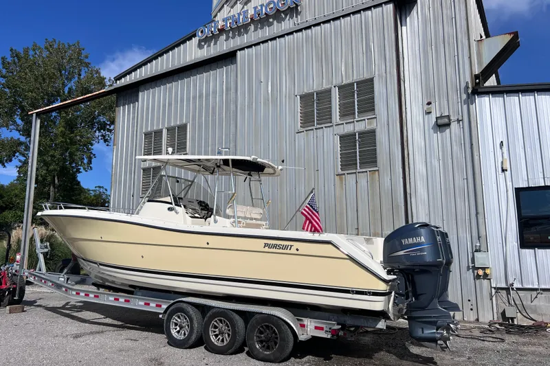 Slide: The Image of 2007 Pursuit C 300 Center Console boat on calm water with twin Yamaha engines. - 3