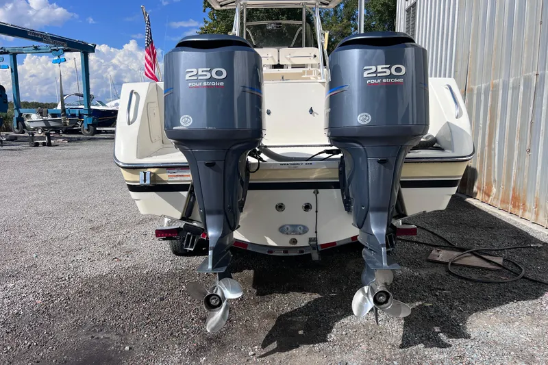 Slide: The Image of 2007 Pursuit C 300 Center Console boat cruising on a calm lake with trees in the background. - 4