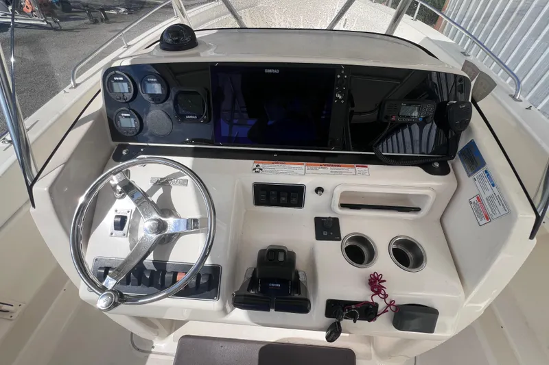 Slide: The Image of 2007 Pursuit C 300 Center Console boat cruising on a calm lake. - 5