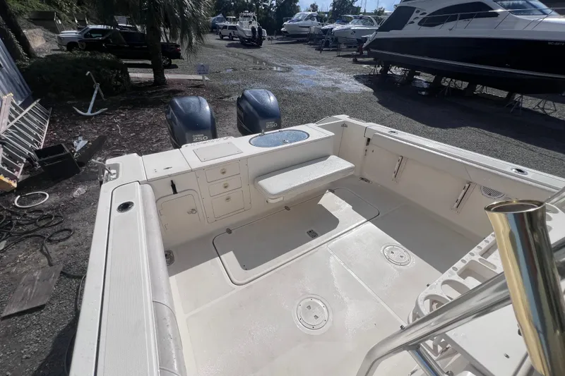 Slide: The Image of 2007 Pursuit C 300 Center Console boat cruising on a calm lake with trees in the background. - 8