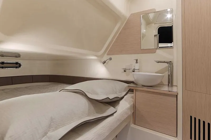 Slide: The Image of Manufacturer Provided Image: 2025 Chris-Craft Catalina 30 cabin interior with bed, sink, and mirror. - 12