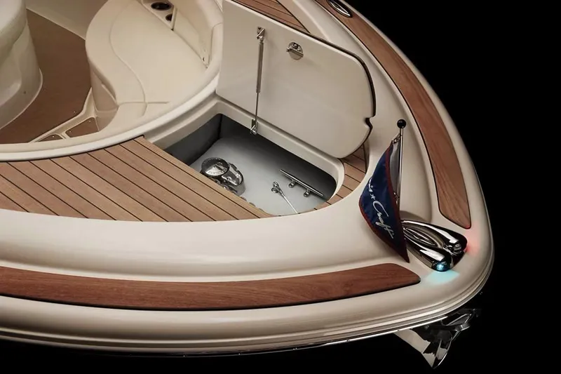 Slide: The Image of Manufacturer Provided Image: 2025 Chris-Craft Catalina 30 boat deck with open storage compartment and elegant wood finish. - 5