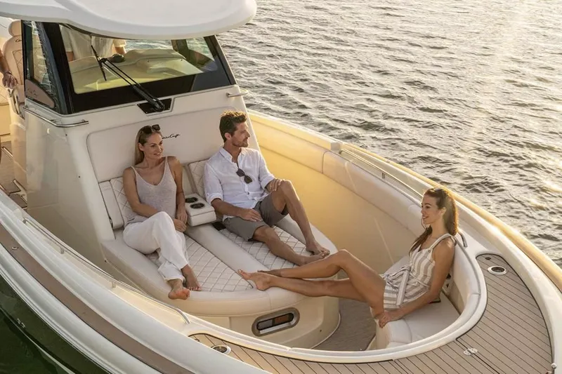 Slide: The Image of Manufacturer Provided Image: 2025 Chris-Craft Catalina 30 with people relaxing on deck at sunset. - 6