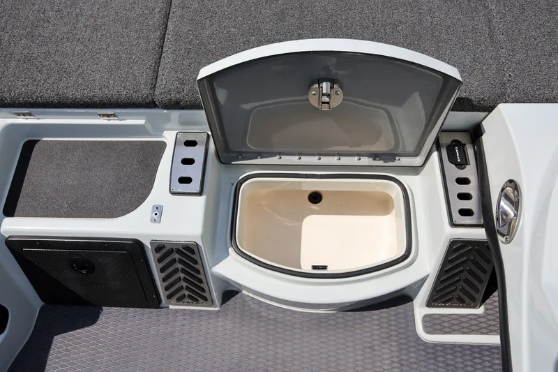 Slide: The Image of 2020 Caymas CX 20 PRO boat storage compartment with open lid, showcasing interior design. - 12