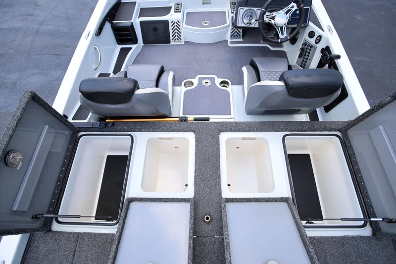 Slide: The Image of 2020 Caymas CX 20 PRO boat interior with open storage compartments and dual seats. - 6