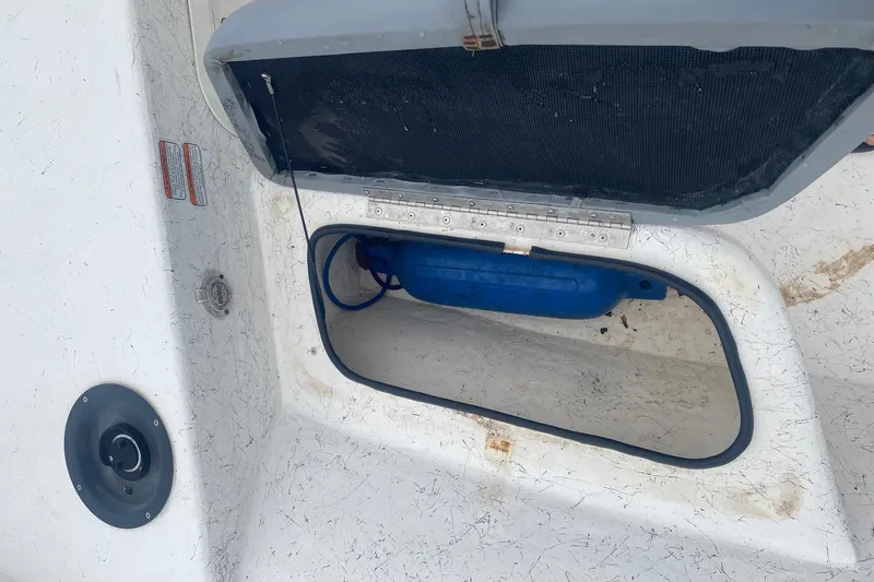 Slide: The Image of Open storage compartment on a 2006 Mako 191 Inshore boat, showing interior details. - 10