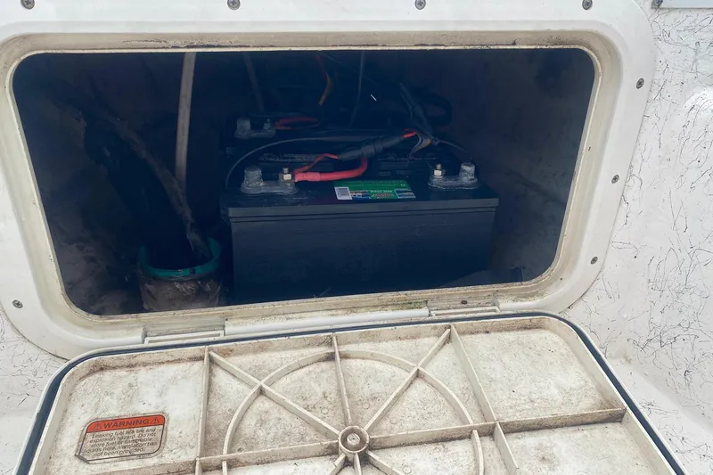 Slide: The Image of Battery compartment of a 2006 Mako 191 Inshore boat, showing installed battery. - 12