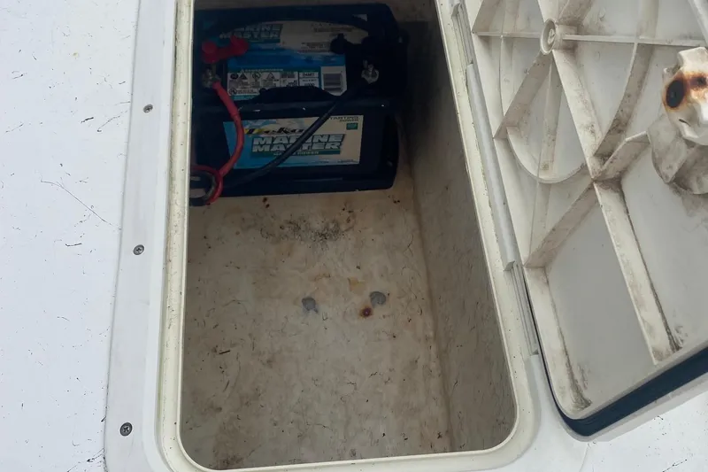 Slide: The Image of Open storage compartment on 2006 Mako 191 Inshore boat with marine battery inside. - 6