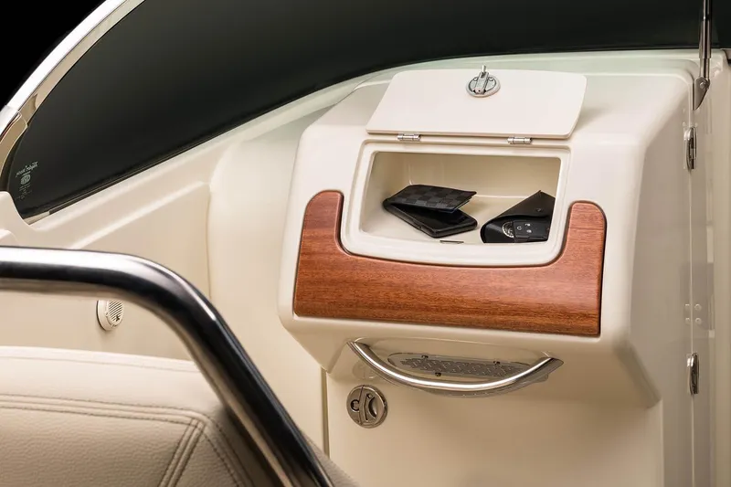 Slide: The Image of Manufacturer Provided Image: 2025 Chris-Craft Launch 28 GT dashboard storage with wood accents and personal items. - 12