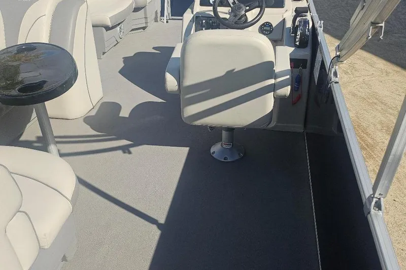 Slide: The Image of 2019 Starcraft EX 20 C boat interior with seating and steering console. - 3