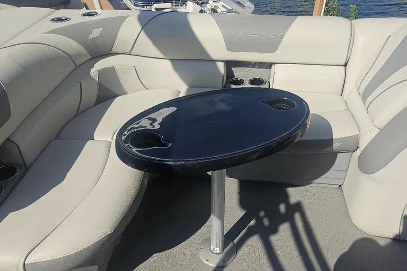 Slide: The Image of 2019 Starcraft EX 20 C boat interior with cushioned seating and a round table. - 4
