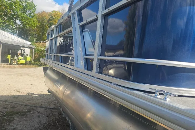 Slide: The Image of 2019 Starcraft EX 20 C pontoon boat with blue exterior, parked outdoors. - 6