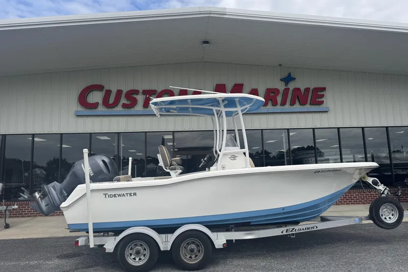 Slide: The Image of 2020 Tidewater 210 CC Adventure boat on trailer at Custom Marine dealership. - 1