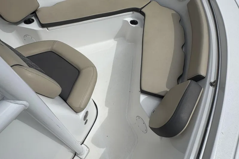 Slide: The Image of 2020 Tidewater 210 CC Adventure boat interior with beige and black seating. - 12