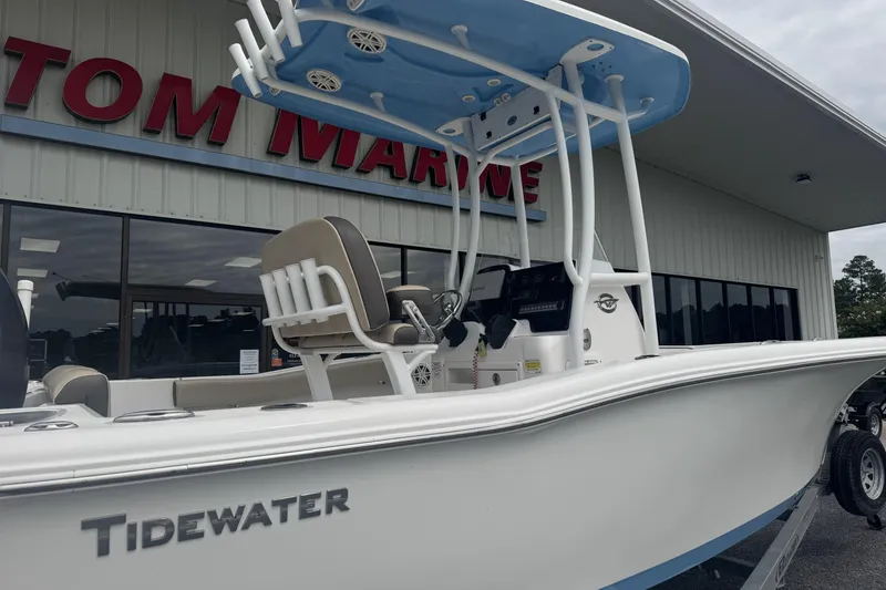 Slide: The Image of 2020 Tidewater 210 CC Adventure boat displayed outside a marine dealership. - 3