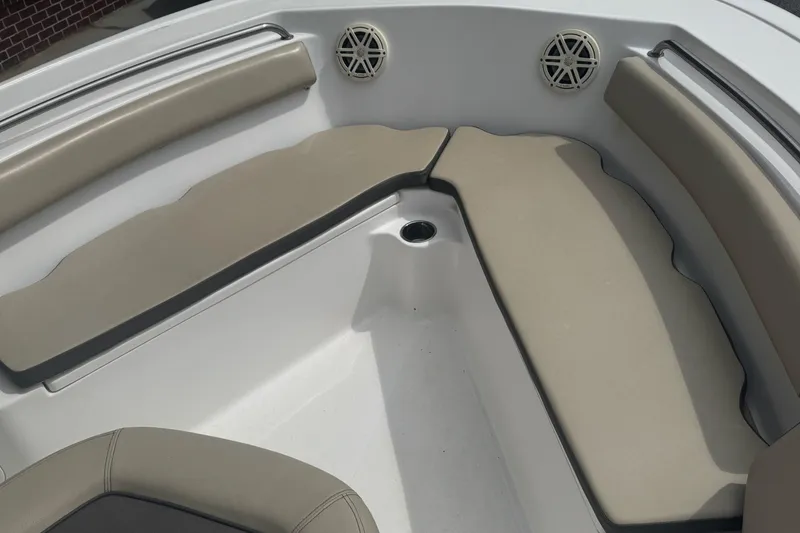 Slide: The Image of 2020 Tidewater 210 CC Adventure boat interior with cushioned seating and speakers. - 8