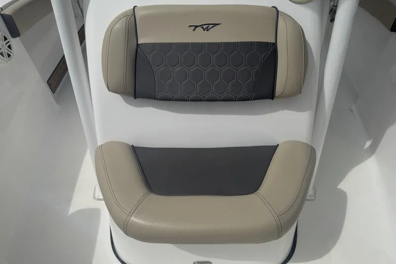 Slide: The Image of Tidewater 210 CC Adventure 2020 boat seat with beige and black upholstery. - 9