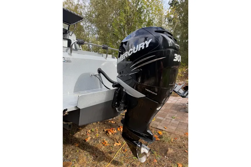 Slide: The Image of 2017 KingFisher 2825 Offshore boat with Mercury 300 Verado outboard motor, parked outdoors. - 13