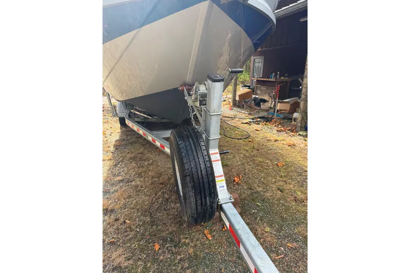 Slide: The Image of 2017 KingFisher 2825 Offshore boat on trailer, parked on grassy area. - 20