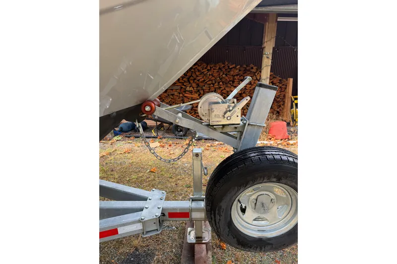 Slide: The Image of 2017 KingFisher 2825 Offshore boat trailer with winch and spare tire, parked outdoors. - 21