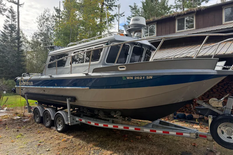 Slide: The Image of 2017 KingFisher 2825 Offshore boat on trailer, parked outdoors near a house. - 22