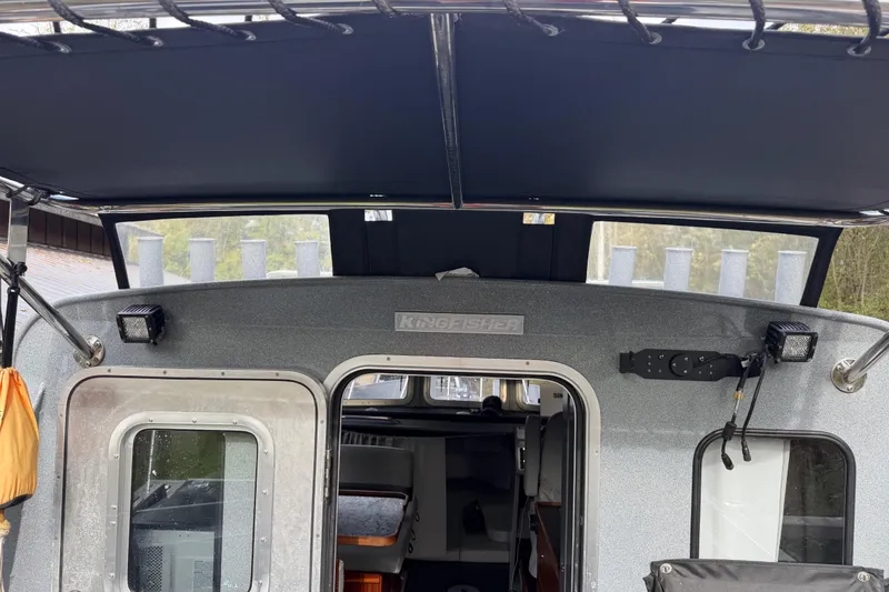 Slide: The Image of 2017 KingFisher 2825 Offshore boat interior with canopy and door view. - 23
