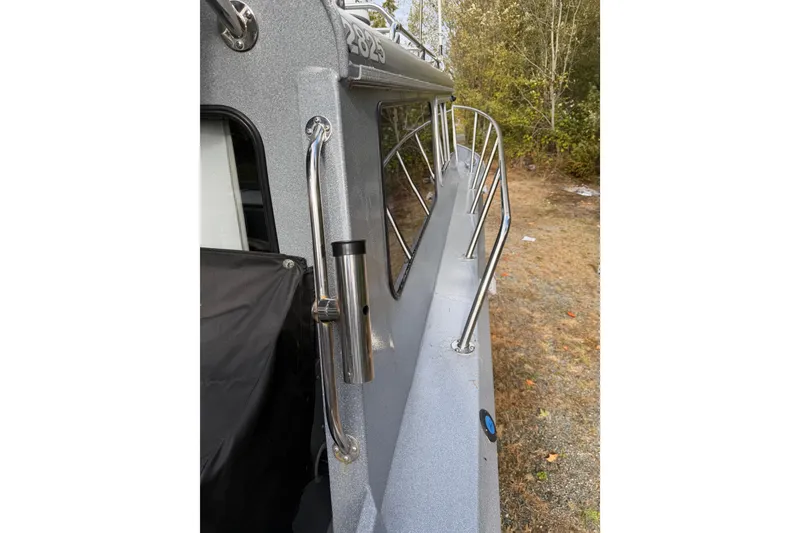 Slide: The Image of 2017 KingFisher 2825 Offshore boat side view with railing and handle. - 24