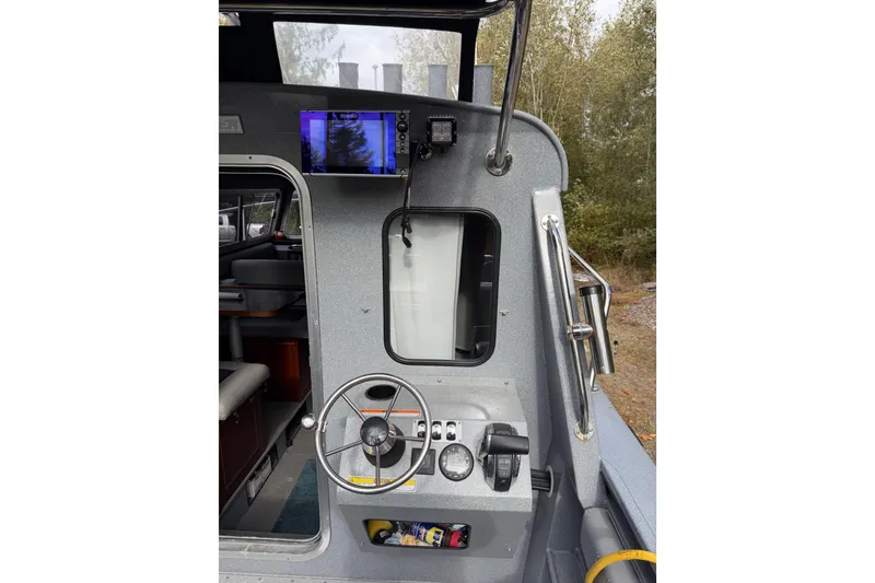 Slide: The Image of Interior view of 2017 KingFisher 2825 Offshore boat cockpit with steering wheel and navigation equipment. - 25
