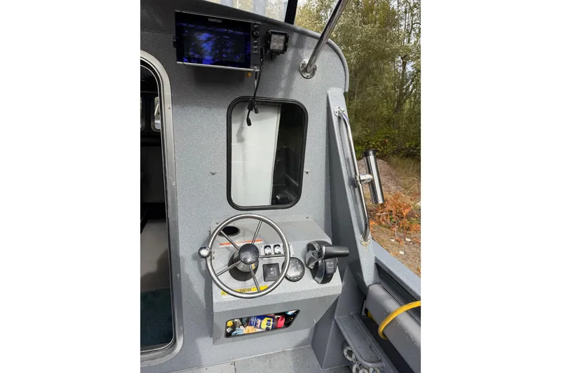 Slide: The Image of 2017 KingFisher 2825 Offshore boat helm with steering wheel and navigation equipment. - 27