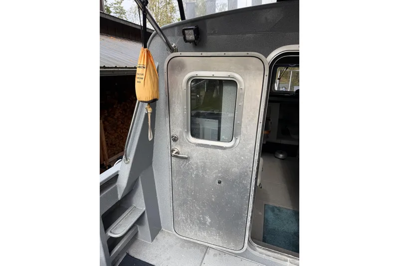 Slide: The Image of 2017 KingFisher 2825 Offshore boat door with rescue throw bag hanging nearby. - 28
