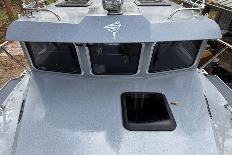 Slide: The Image of 2017 KingFisher 2825 Offshore boat, silver exterior, front view with windows and hatch. - 32