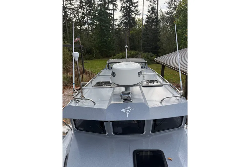 Slide: The Image of 2017 KingFisher 2825 Offshore boat with radar, docked near forested area. - 33