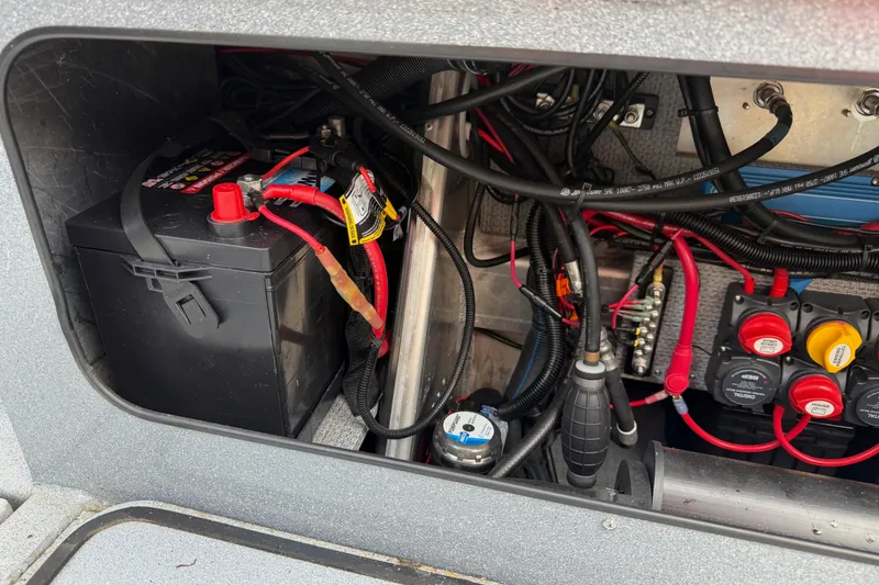 Slide: The Image of Battery compartment of 2017 KingFisher 2825 Offshore boat with wiring and switches. - 39